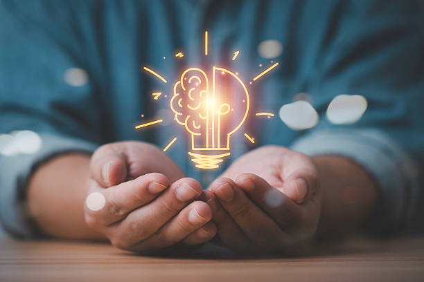 istock Hands holding a glowing brain and lightbulb symbol representing creativity innovation idea development and problem solving showing the concept of intelligence strategic thinking and modern inspiration 2251185520