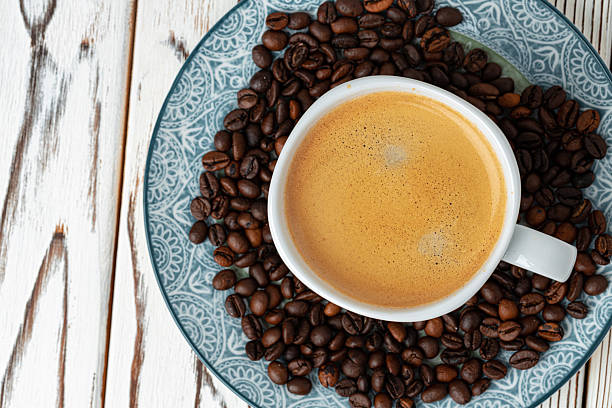 istock Coffee cup on roasted coffee beans top view 2251186651