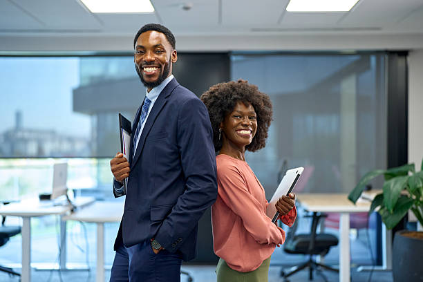 istock Confident business colleagues smiling standing back to back in office 2251188622