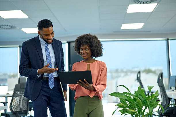 istock Colleagues collaborating on tablet in modern office 2251188649