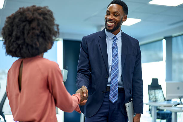 istock Business professionals shaking hands in modern office 2251188788