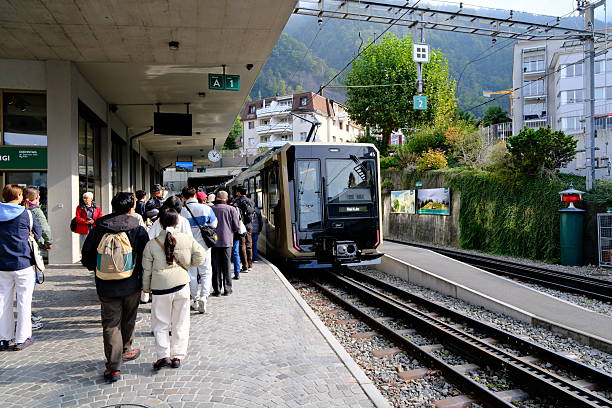 Vitznau,Switzerland-Sep.30th 2025: Passengers boarding cogwheel train at Vitznau railway station platform, Switzerland