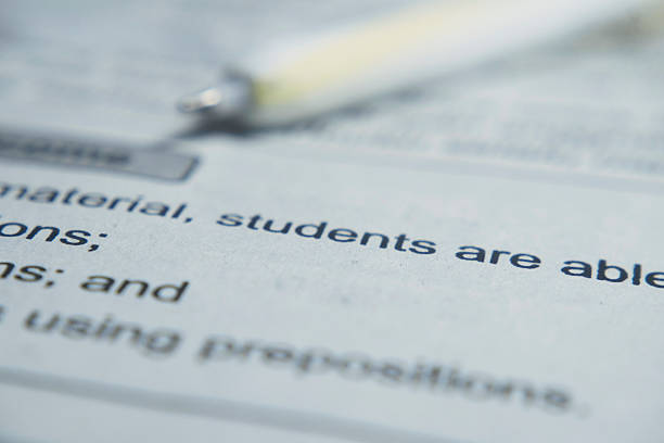 istock text book with focused of students word 2251191366