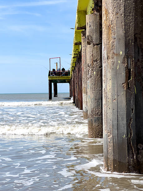 istock Coastal Pier Structure with Ocean Waves Under Clear Blue Sky 2251191568