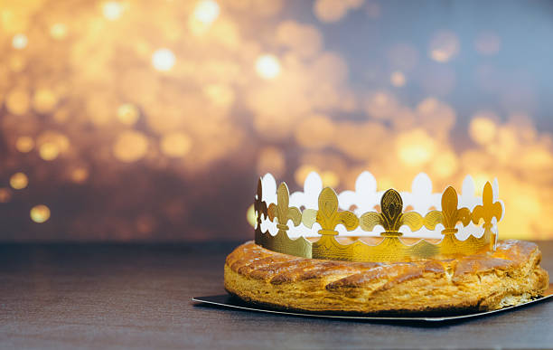 istock Almond royal galette with crown on stone table with fire bokeh. 2251194702