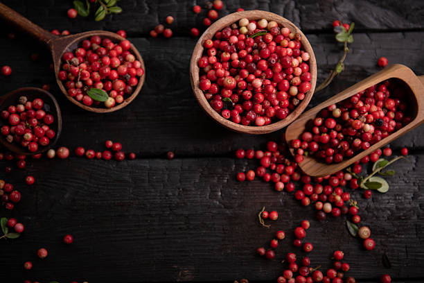 Red fresh healthy cranberries in a street food market ready to sell and eat, close up.