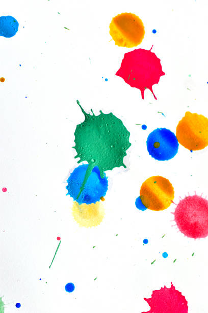 A textured design created by randomly dropping drops of watercolor paint in different shades onto a white background.