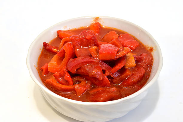 Sweet pepper salad with tomato sauce. Lecho. Salad in a round bowl.