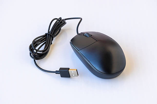 istock Close-up of a modern, ergonomic black wired optical computer mouse with a scroll wheel and USB connection cord, isolated on a white background. Technology and design concept. 2251199602
