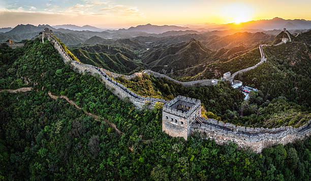 istock Great Wall of China winding through lush mountains at sunset, an ancient architectural marvel and iconic landmark, attracting tourists for historical exploration and travel adventures in Asia 2251199840