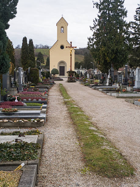 Klosterneuburg, Austria - January 5, 2018: Cemetery grounds with gravestones under cloudy winter sky showing solemn atmosphere in editorial context.