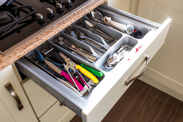 istock Overhead view of open kitchen drawer with array of cutlery and utensils 2251201538