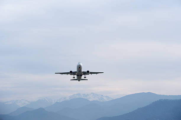 istock Airplane Climbing into Winter Sky Above Snowy Mountain Landscape. 2251209676