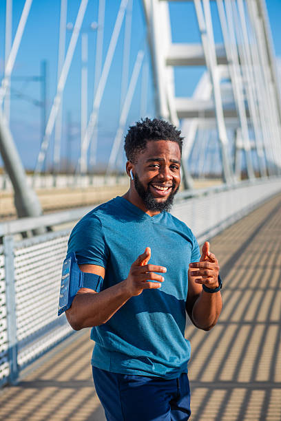istock Young Black athlete smiling on bridge 2251211212