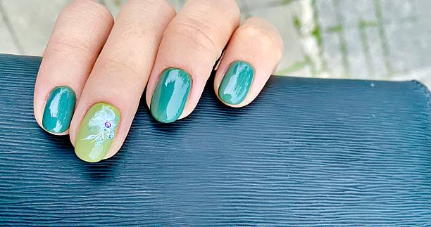 istock Green Gel Manicure with Floral Accent Nail Design. 2251214421