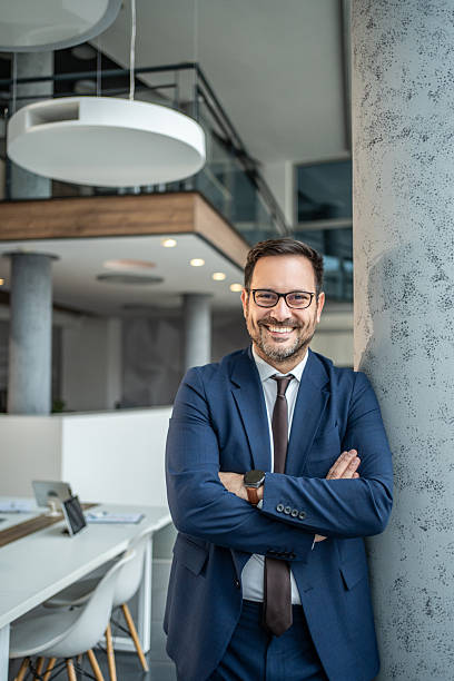 istock Confident businessman posing with crossed arms in office 2251215626