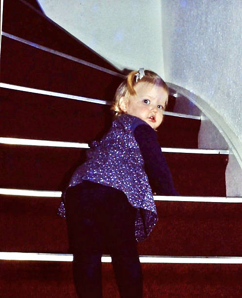 Retro Toddler Girl learning on staircase