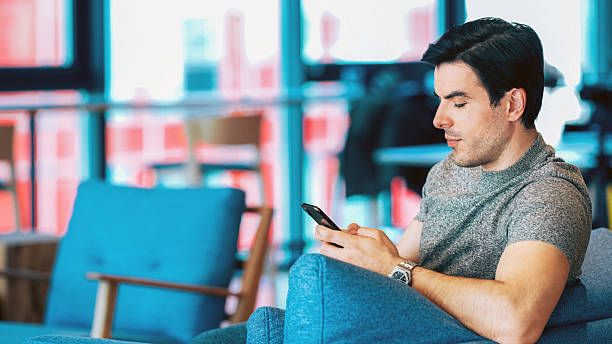 istock Businessman using smartphone in modern coworking space 2251220914