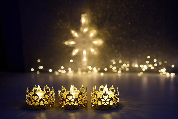 istock Candlelit Starry Night. Three ornate candles glow with a star-shaped light backdrop 2251222915