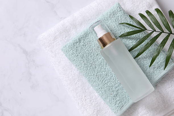 istock Bath towels and cosmetic bottle on the table 2251223958
