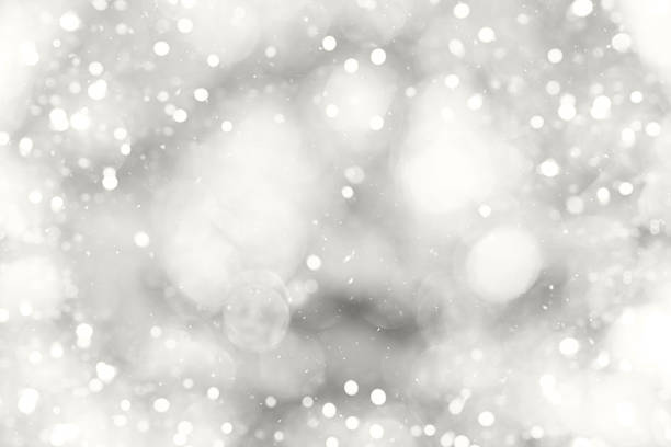 istock Soft snowy bokeh background with bright light particles in grayscale for winter and festive design 2251224096