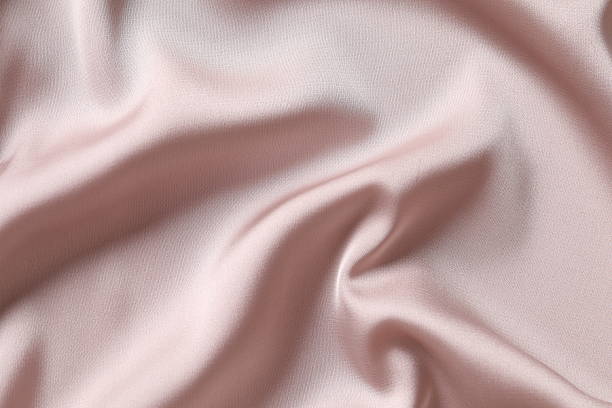 istock Beige silk satin. Shiny smooth fabric. Soft folds. Luxury background with space for design. Flat table, top view 2251224169