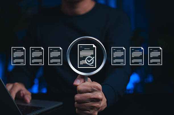 istock Document verification concept. Person holding magnifying glass highlighting approved file, symbolizing data review, quality control, check, audit, certificate, legal approval, information validation, 2251225111