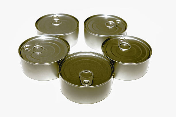 Group of tuna cans arranged together on white surface