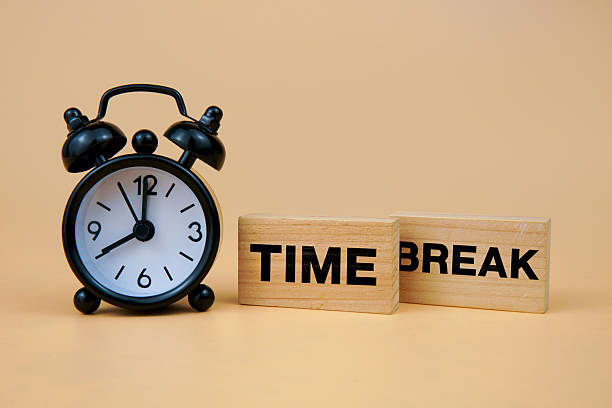 istock Break time concept with an alarm clock and wooden blocks spelling TIME BREAK, symbolizing rest period, pause reminder, work-life balance, productivity reset, and mental wellness. 2251227418
