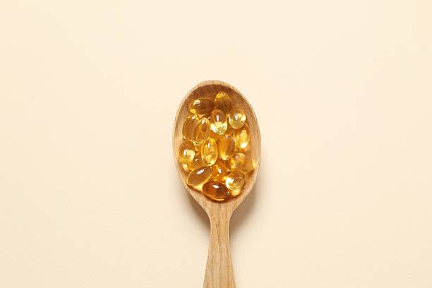 istock Fish oil tablets in wooden spoon. Biologically active additives. Omega 3, 6, omega 9, vitamin A, E, D 2251228301