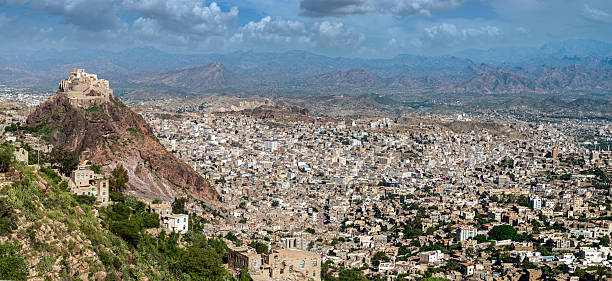 Taiz city panorama with historic Al-Qahira Castle on a mountain against a cloudy sky