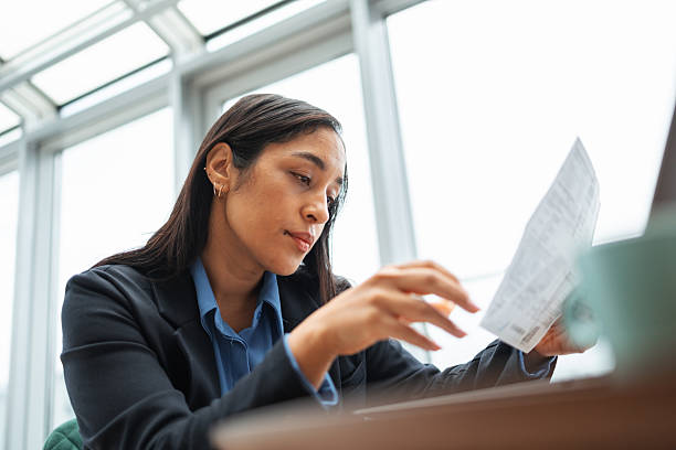 istock Businesswoman reading financial document in modern office 2251229659