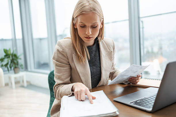 istock Businesswoman working with documents and laptop in office 2251229687