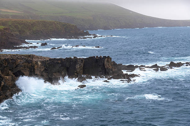 Rugged West coast of Ireland near Dingle, Kerry county during a storm with high waves hitting the rocky coastline