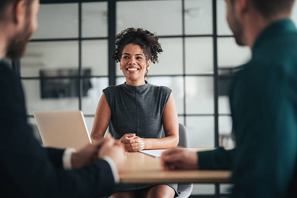 istock Insurance agents consulting clients in modern office 2251230383