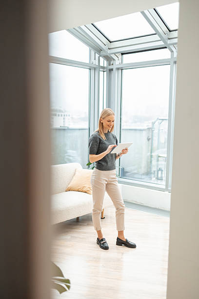 istock Professional woman using digital tablet in modern apartment 2251231068