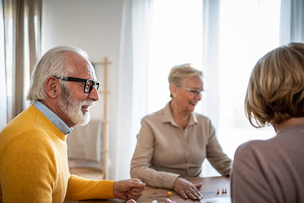 istock Senior friends enjoying leisure time playing board game 2251231204