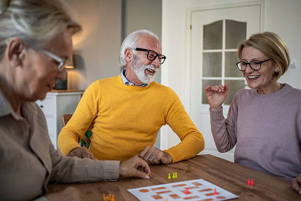 istock Senior friends enjoying leisure time playing board game 2251231227