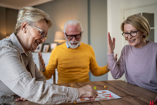 istock Senior friends enjoying board game while spending leisure time 2251231243