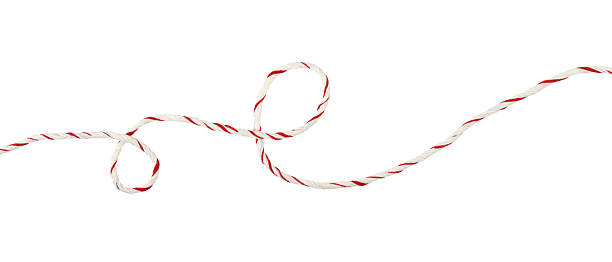 istock Curled white and red Christmas wrapping rope in a line arrangement isolated on white 2251231299