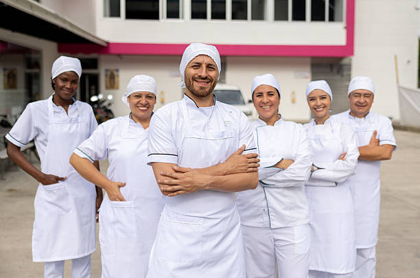 istock Happy group of bakers smiling outdoors at a bakery 2251231451
