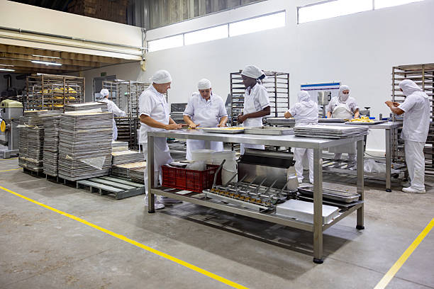 istock Baker training new employees working at an industrial bakery 2251231587