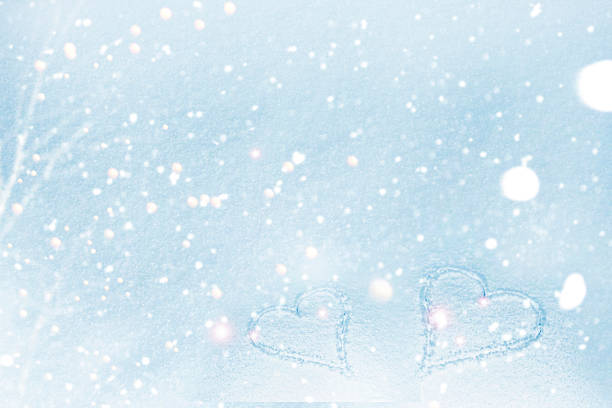 Abstract winter soft background with two hearts in the snow. Valentine's Day.