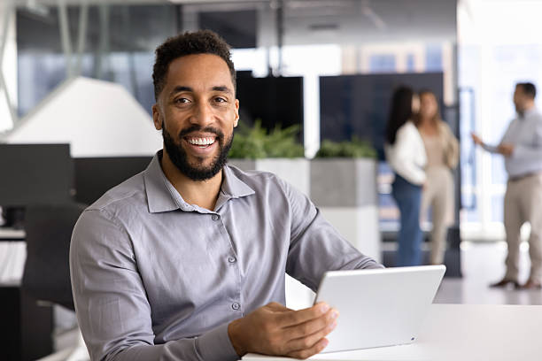 istock Positive African American manager posing at office workplace 2251233100