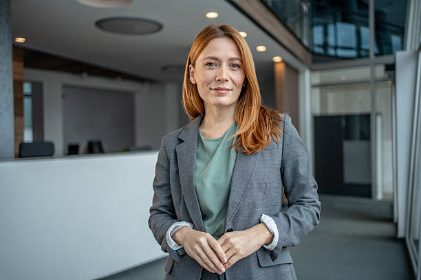 istock Businesswoman standing in modern office building with confident expression 2251234105