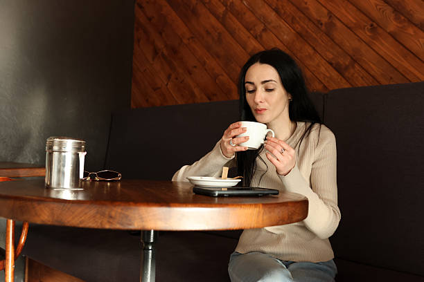 istock A woman drinks coffee in a cafe at a table. 2251234261