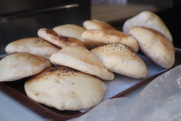 istock Freshly baked pita bread on a tray in a bakery 2251235292