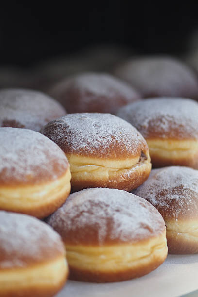 istock Freshly baked donuts dusted with powdered sugar displayed 2251235885