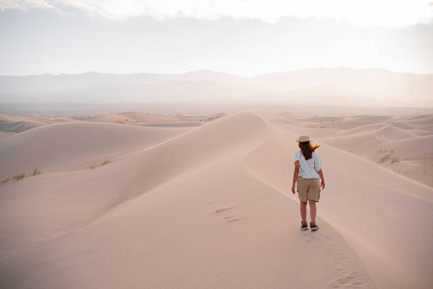 istock Woman walking in the desert. 2251239001