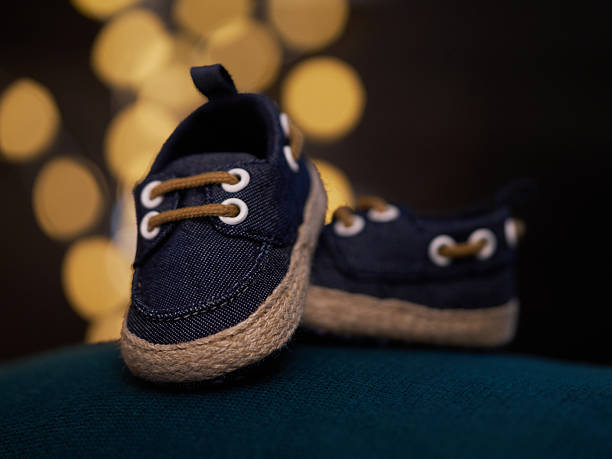 istock Blue baby shoes on warm blurred background 2251239609